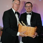Paul Jarvis (right) of Faccenda collecting his champagne raffle prize from special guest Geoff Hurst.