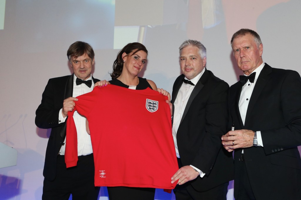 L-R: Professor  Roger Kirby, representing the Urology Foundation with Fran White and Chris Price of Graham White & Co collecting their replica 1966 England shirt from Sir Geoff Hurst.