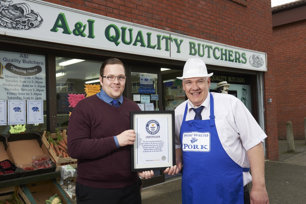 Graeme Sharp, QMS marketing executive presents Inverness butcher, Ali Paul with a certificate officially making him the holder of the first Guinness World Record for the making the most sausages in one minute.