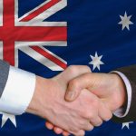 Handshake in front of Australian flag