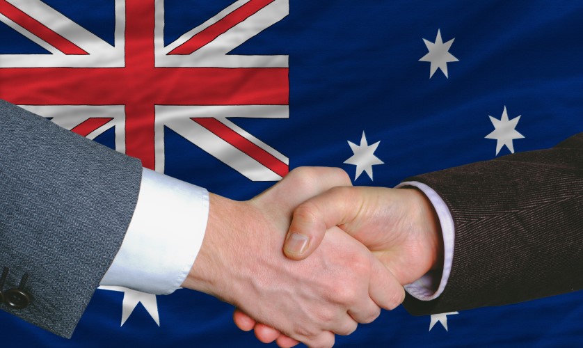 Handshake in front of Australian flag